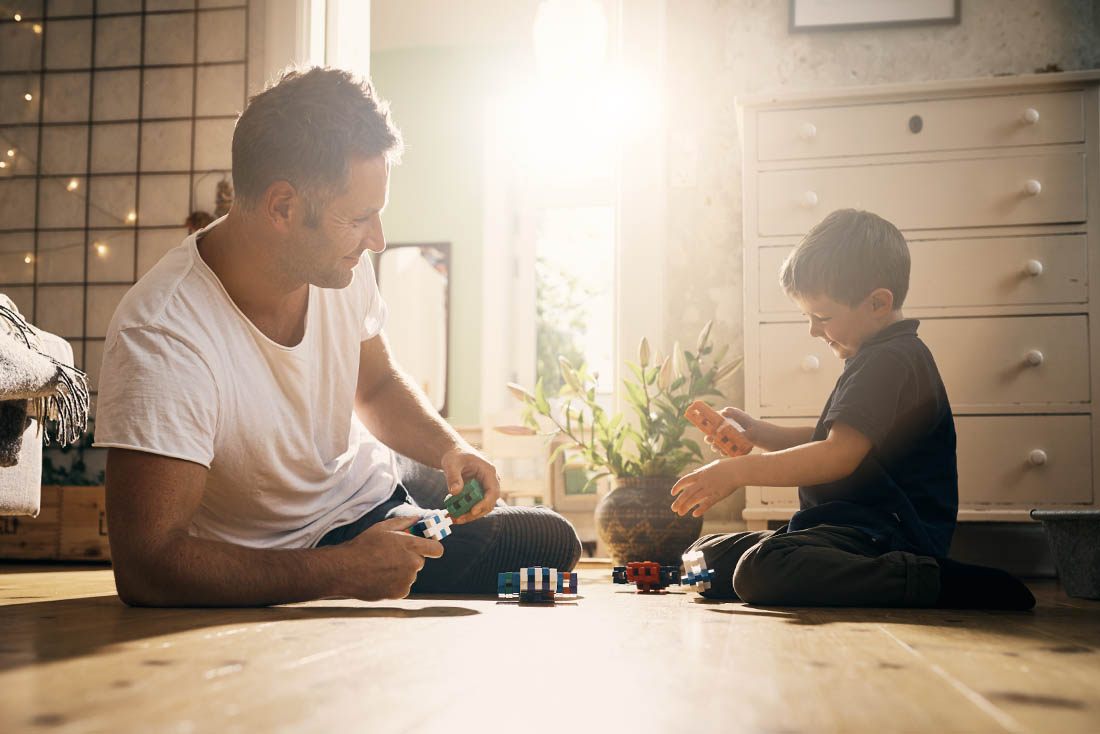 Play is part of the learning process father and son playing with toys